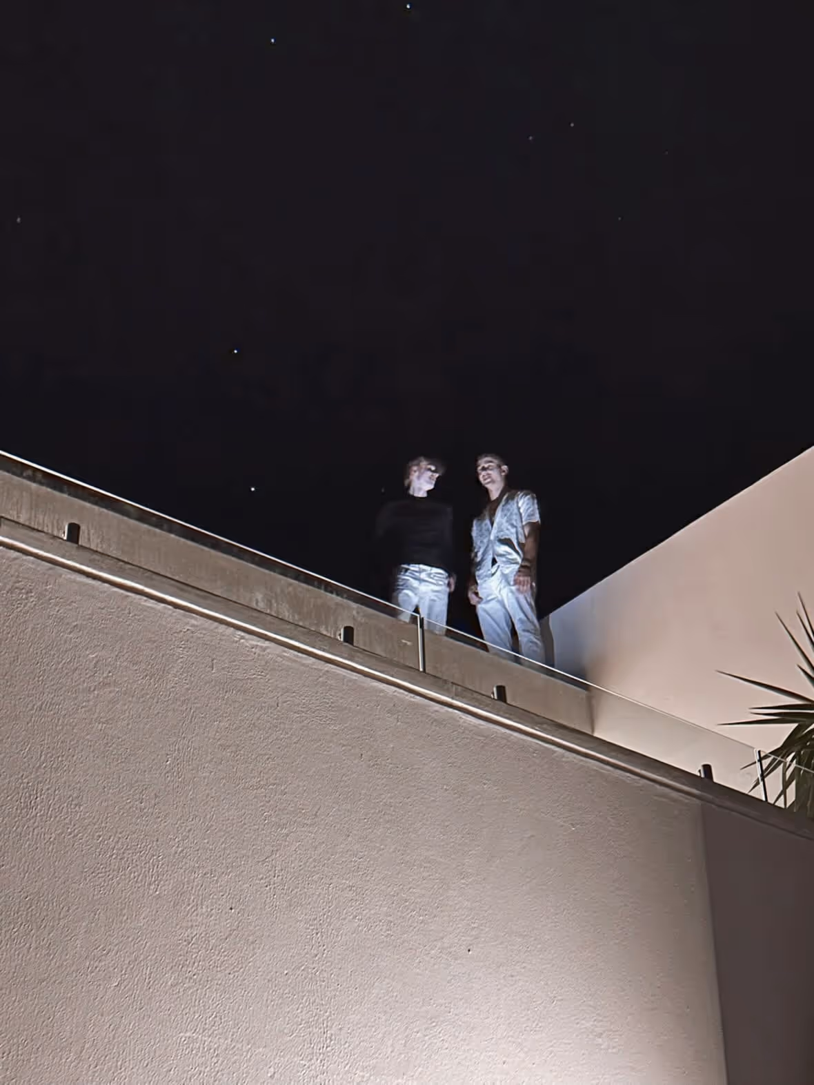 Two Helix founders in a quiet balcony conversation at night in Cape Town