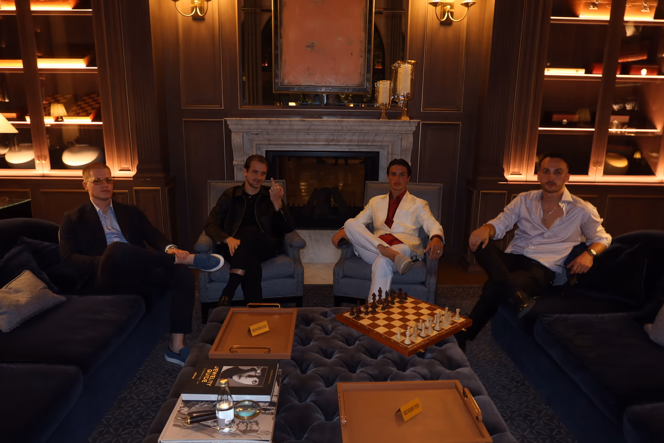 CEOs talking by the fire in a private lounge — a peer group that meets off the record