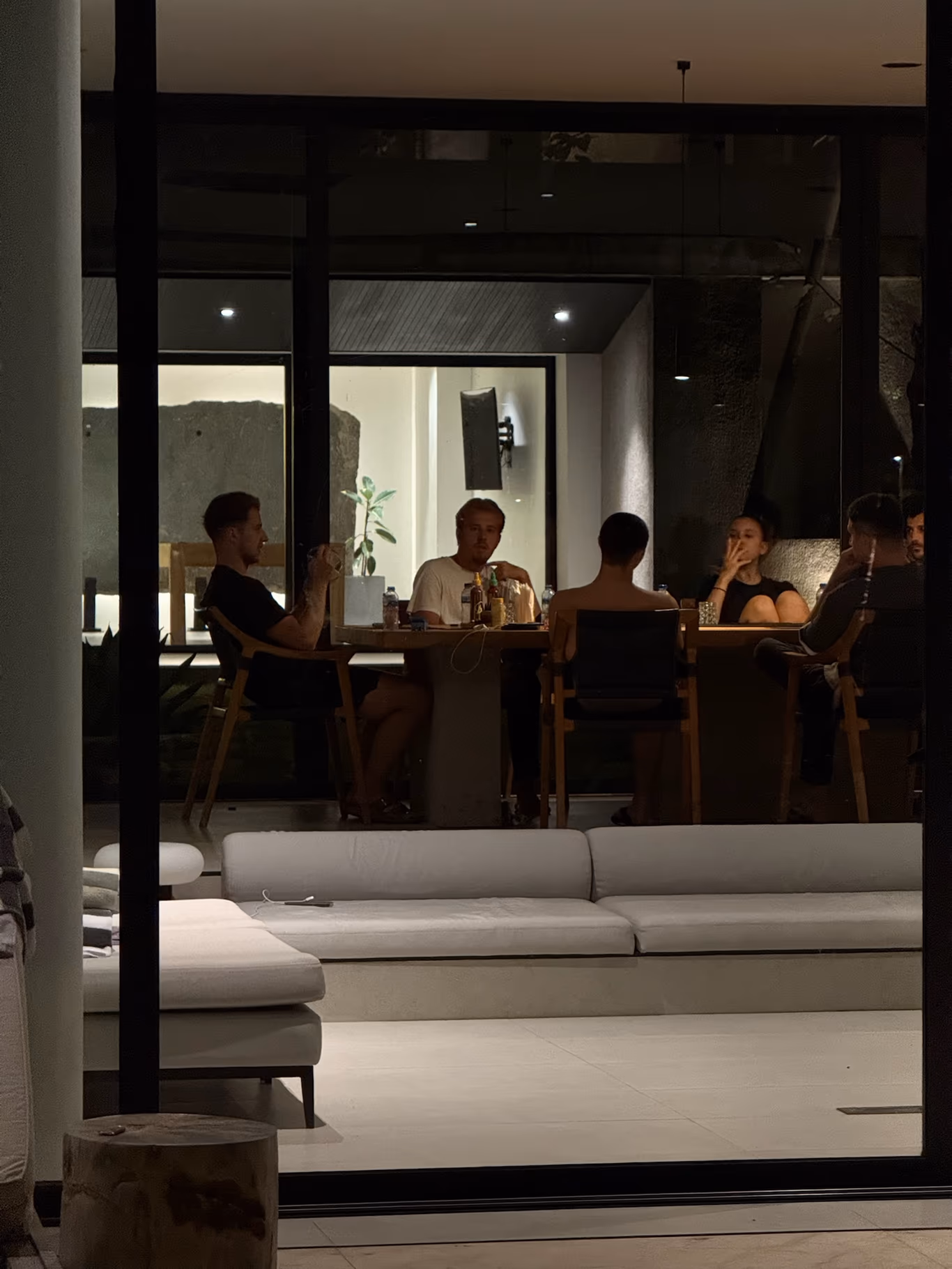 Founders gathered in the evening by floor-to-ceiling windows at a Helix villa