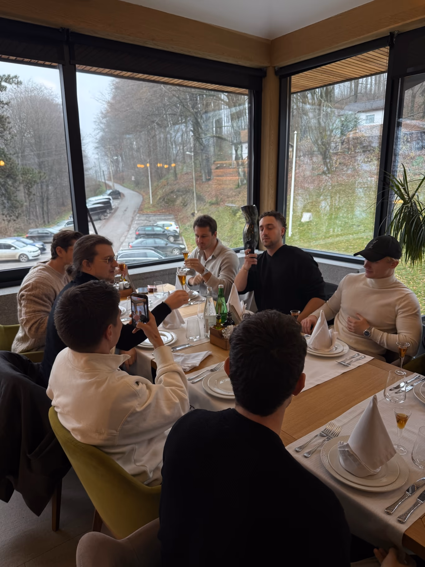 Helix founders laughing around a long dinner table — a founder community that actually convenes