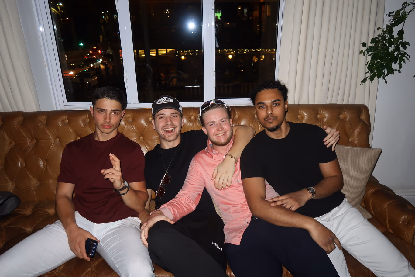 Founders relaxed together on a couch between sessions — community off the clock