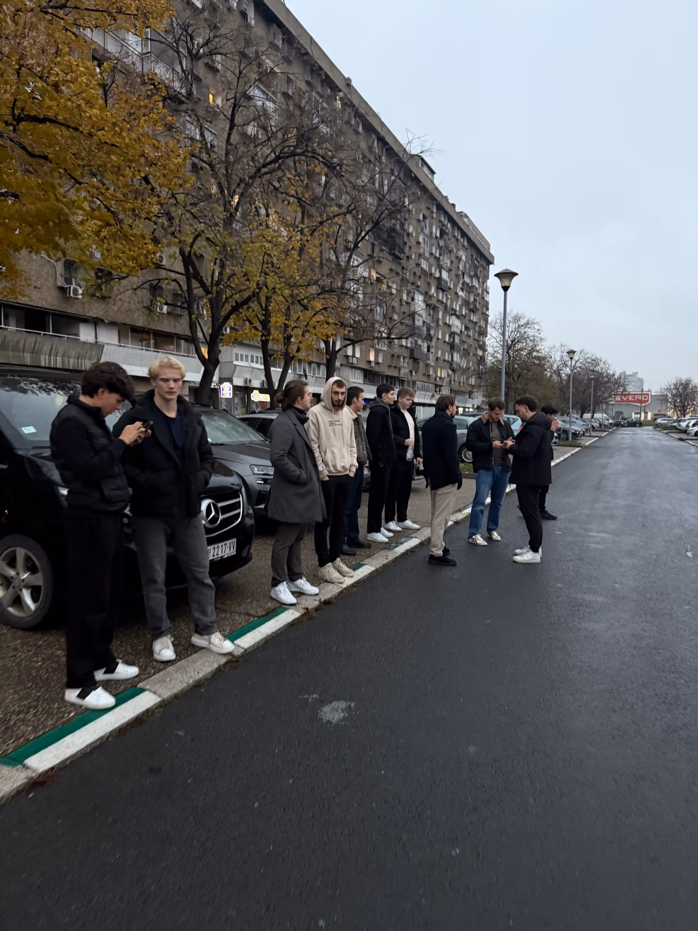 Founders walking a tree-lined city street together on a Helix trip